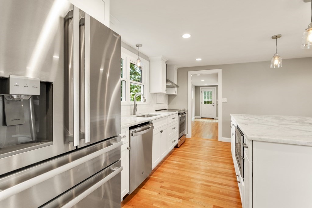 11 Allison Road Saugus, MA 01906 - Photo 7 of 28 a large kitchen with stainless steel appliances granite countertop a refrigerator and a sink