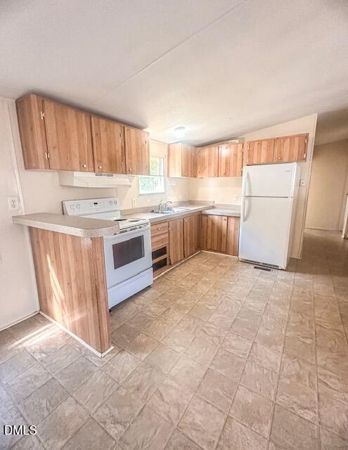 7537 Sam Young Road Oxford, NC 27565 - Photo 16 of 28 a kitchen with a stove a refrigerator a sink and dishwasher with wooden cabinets