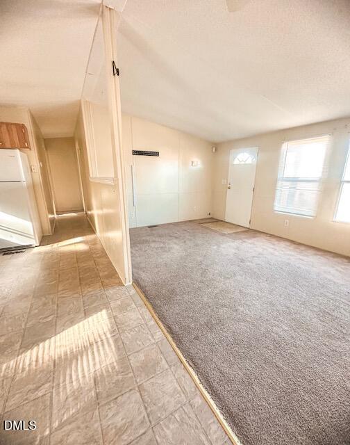 7537 Sam Young Road Oxford, NC 27565 - Photo 10 of 28 a view of a big room with a ceiling fan and windows