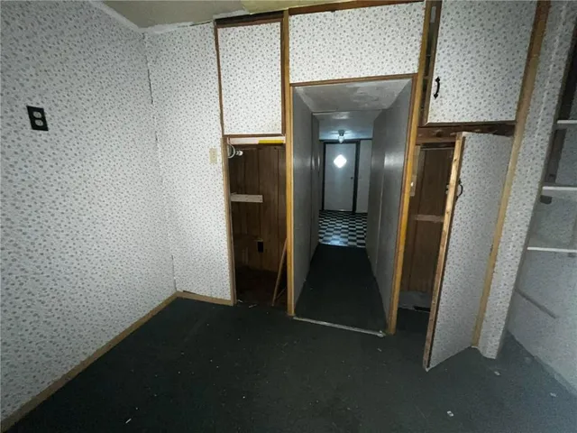 a view of hallway with stairs and a wooden floor