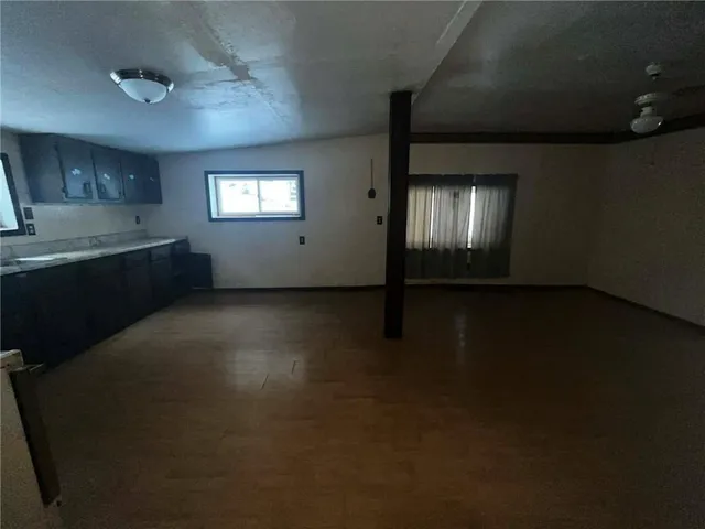 an empty room with a empty space and windows