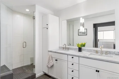 a bathroom with a granite countertop sink mirror and double