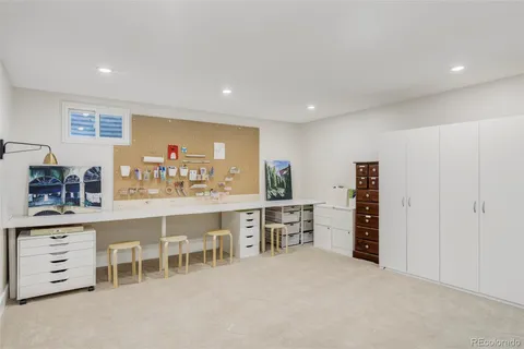 a room with furniture a sink a desk and chairs in it