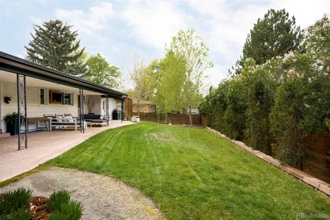 a backyard of a house with yard barbeque oven and outdoor seating