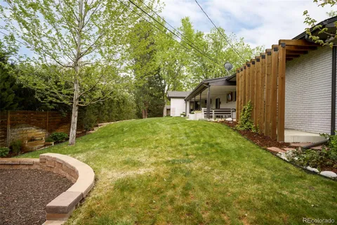 a view of backyard of house with green space