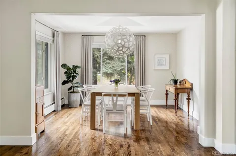 a dining room with furniture window and wooden floor