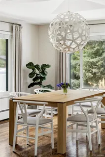 a vase of flowers sitting on a table with a glass top table