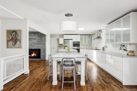 a large white kitchen with a large window