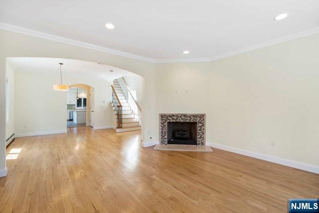 212 Slocum Way, Unit A Fort Lee, NJ 07024 - Photo 12 of 30 a view of empty room with wooden floor and fireplace