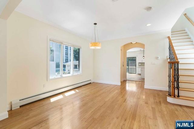 212 Slocum Way, Unit A Fort Lee, NJ 07024 - Photo 13 of 30 a view of an empty room with wooden floor and a window