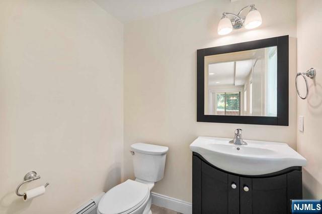 212 Slocum Way, Unit A Fort Lee, NJ 07024 - Photo 27 of 30 a bathroom with a sink a toilet and a mirror