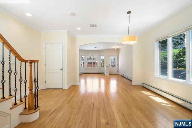 212 Slocum Way, Unit A Fort Lee, NJ 07024 - Photo 10 of 30 a view of an empty room with wooden floor and a window
