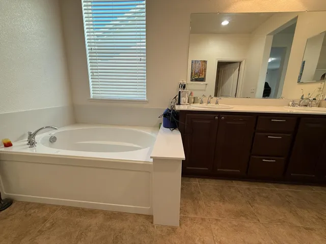 a bathroom with a tub and a shower