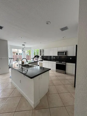 a kitchen with stainless steel appliances granite countertop a sink and cabinets