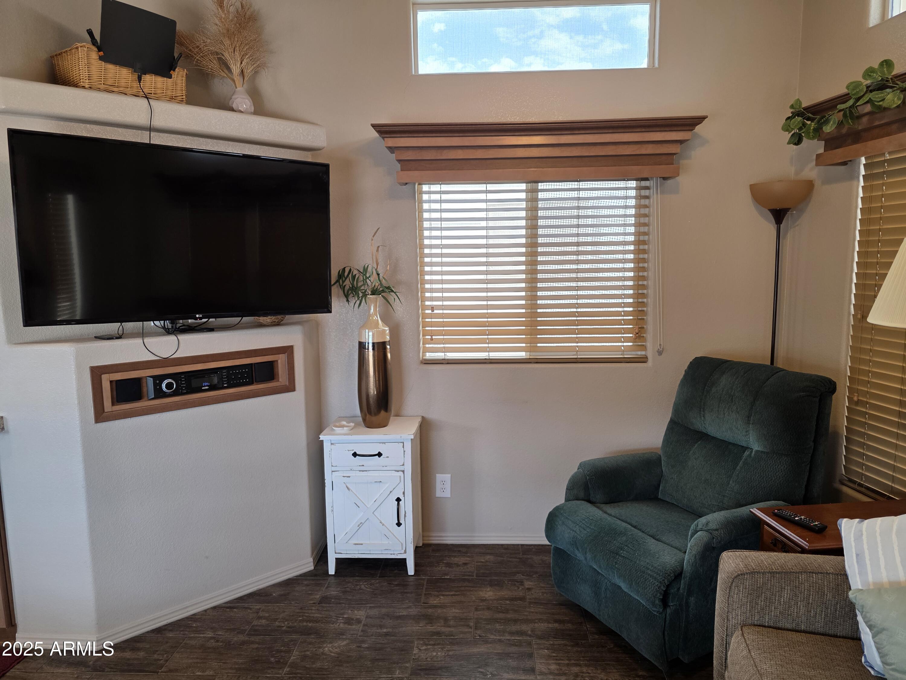 1457 South Zuni Avenue, Unit 457 Apache Junction, AZ 85119 - Photo 7 of 12 a living room with furniture and a flat screen tv