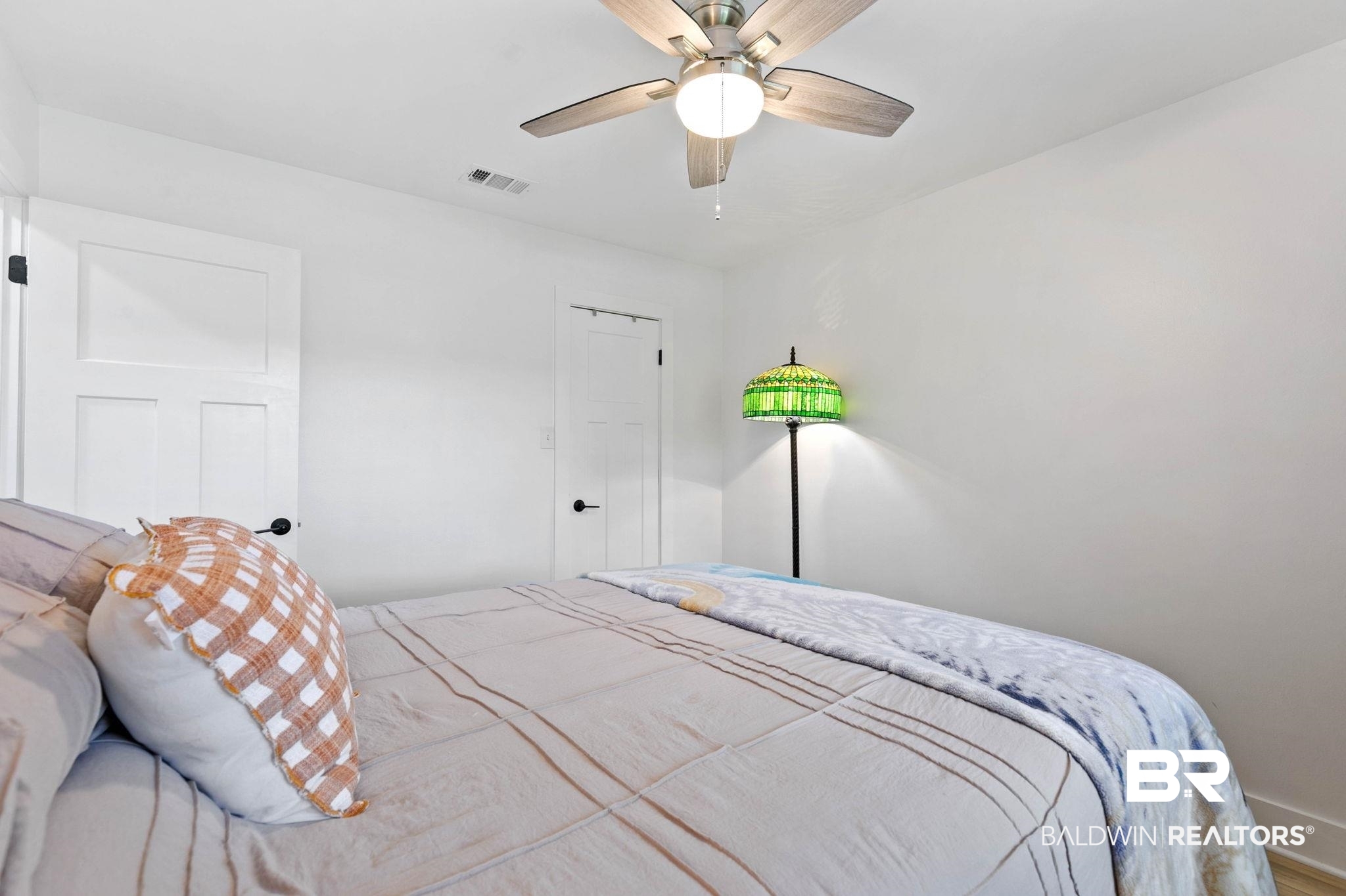 520 Juniper Place Drive Foley, AL 36535 - Photo 22 of 35 Neutral tone walls featuring a ceiling fan with light fixture and two panel doors