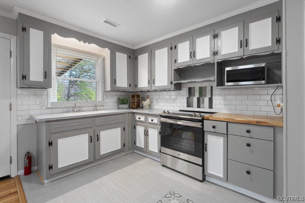 134 Ampthill Road Cartersville, VA 23027 - Photo 41 of 50 a kitchen with stainless steel appliances granite countertop a stove a sink and a microwave