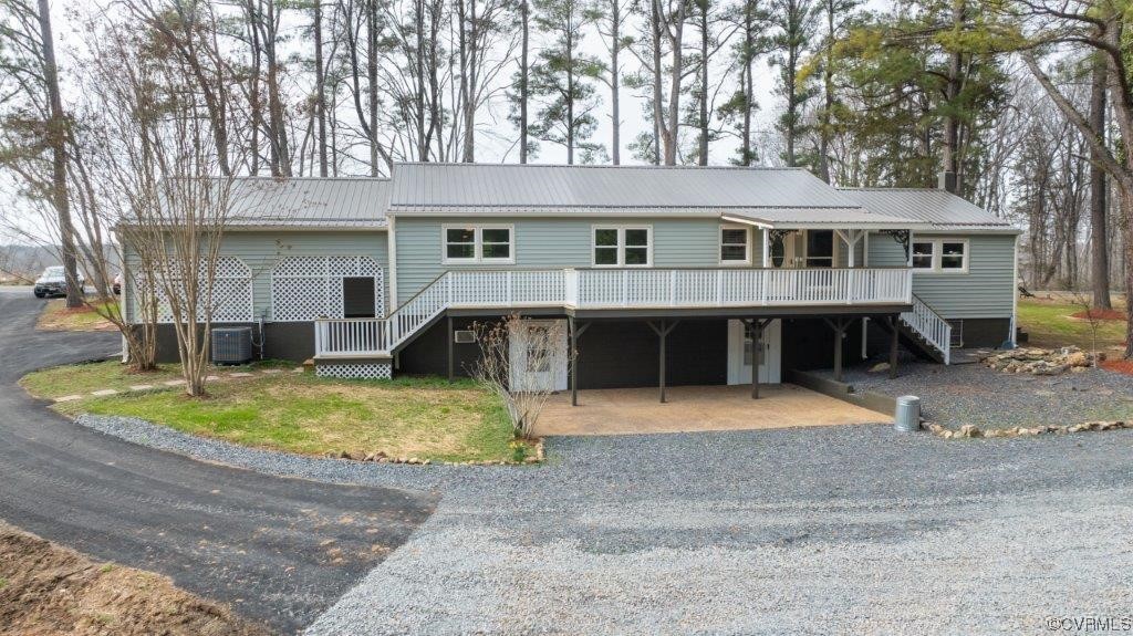 134 Ampthill Road Cartersville, VA 23027 - Photo 6 of 50 a view of a white house with a swimming pool and a yard