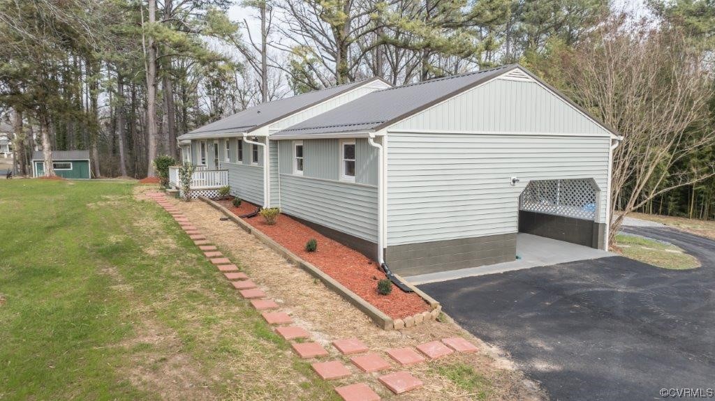 134 Ampthill Road Cartersville, VA 23027 - Photo 8 of 50 a front view of a house with a yard and garage