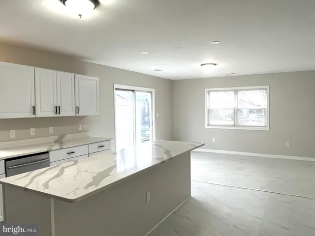a kitchen with a sink cabinets and window