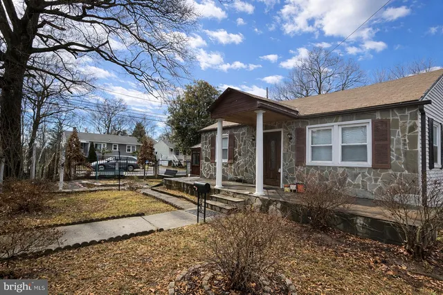 a view of a house with snow on the side of the road