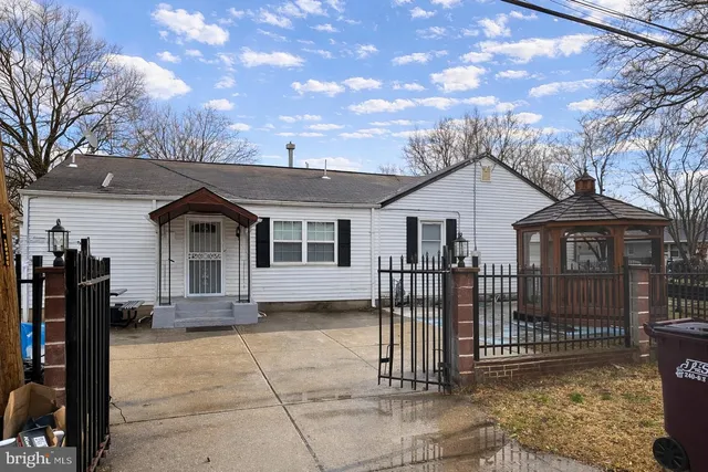 a front view of a house with iron fence