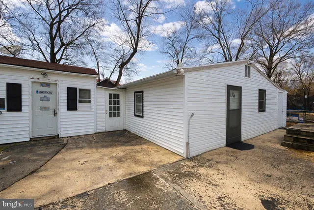 a view of a house with a yard covered in snow