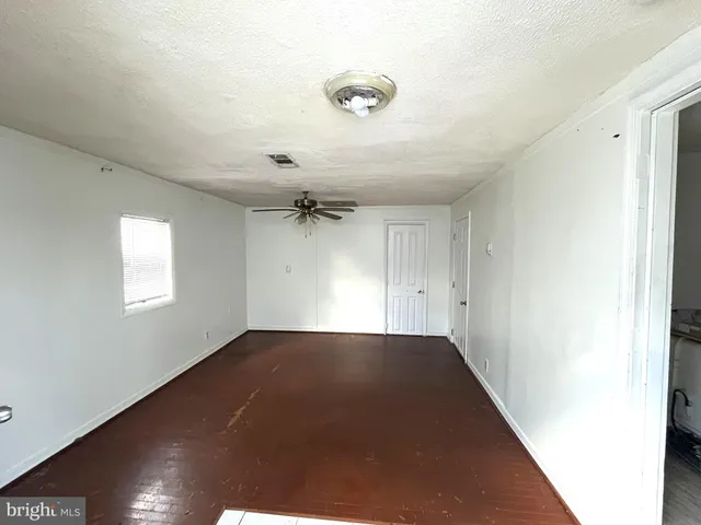 a view of an empty room and a window