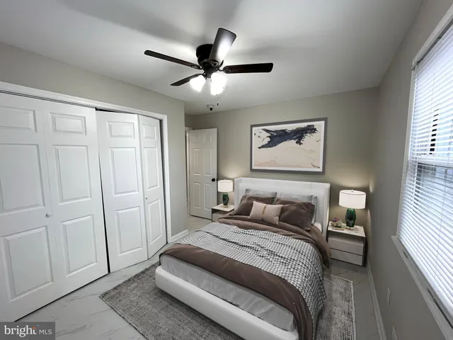 a bedroom with a large bed and a window