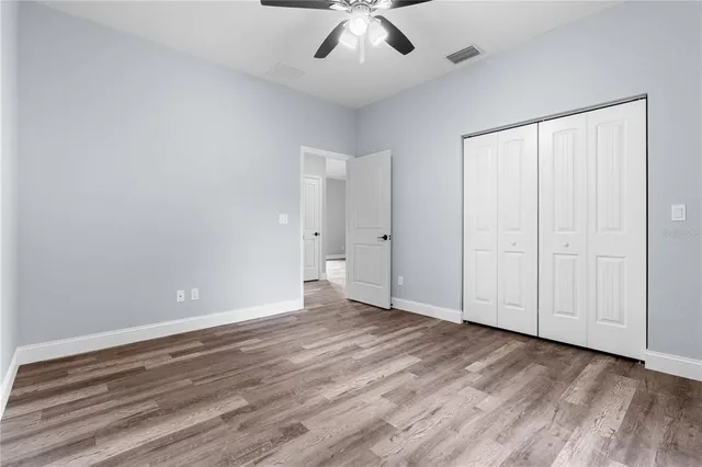 a view of an empty room with wooden floor