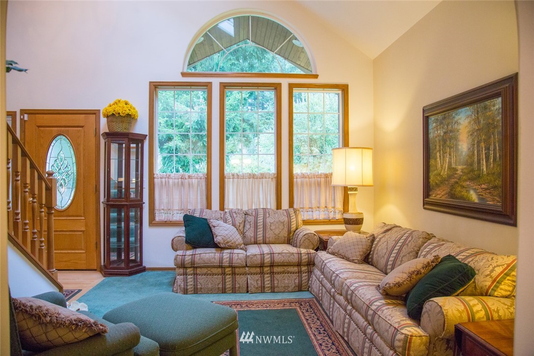 22705 Peter Grubb Road Southeast Renton, WA 98058 - Photo 11 of 40 a living room with furniture and a large window