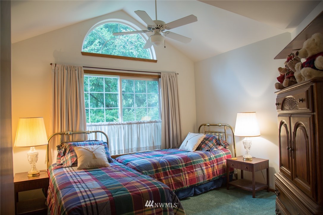 22705 Peter Grubb Road Southeast Renton, WA 98058 - Photo 22 of 40 a bedroom with a bed and a window