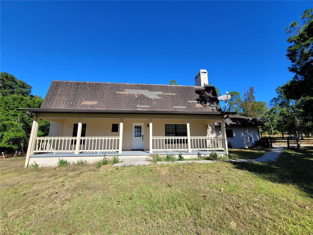 37515 Phelps Road Zephyrhills, FL 33541 - Photo 3 of 25 a front view of a house with a yard