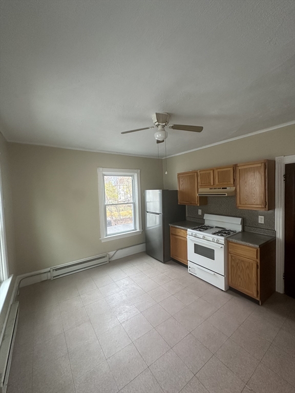 53 Bank Attleboro, MA 02703 - Photo 3 of 7 an empty room with kitchen microwave and windows