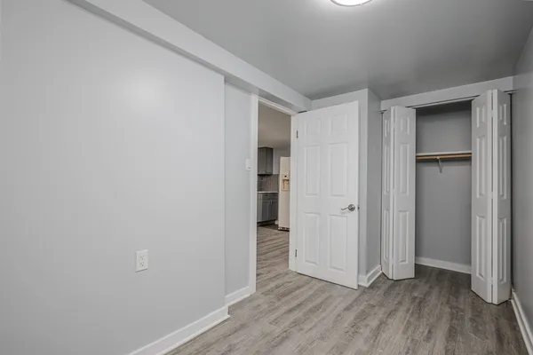a view of empty room with wooden floor
