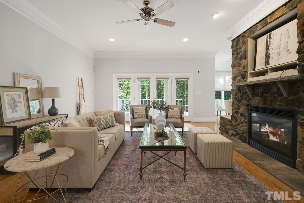 5909 Greenevers Drive Raleigh, NC 27613 - Photo 11 of 30 a living room with furniture large window and a fireplace