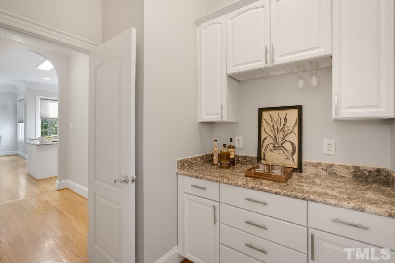 5909 Greenevers Drive Raleigh, NC 27613 - Photo 12 of 30 a bathroom with a granite countertop sink and cabinets