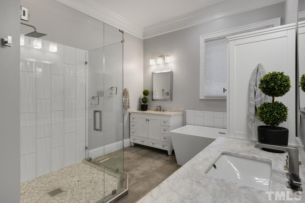 5909 Greenevers Drive Raleigh, NC 27613 - Photo 16 of 30 a bathroom with a tub sink and mirror