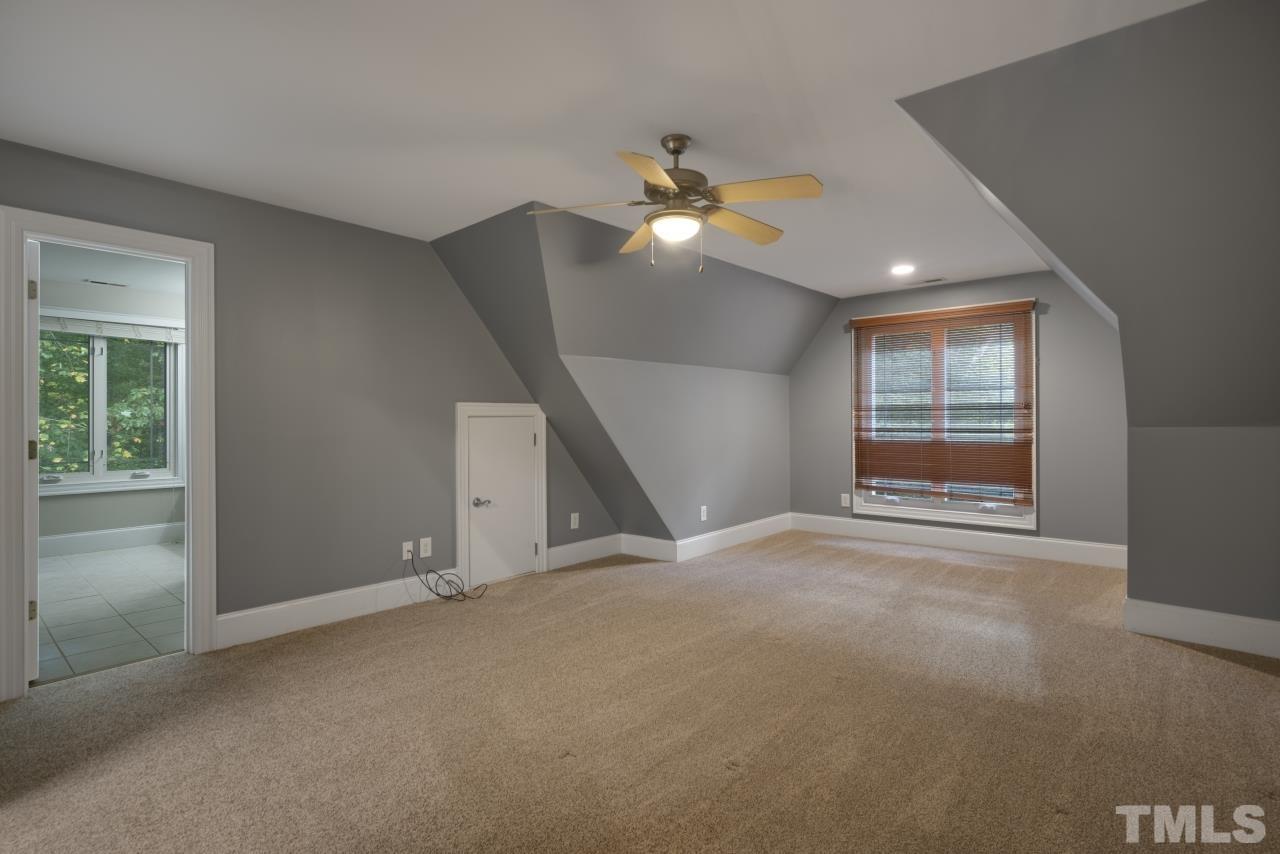 5909 Greenevers Drive Raleigh, NC 27613 - Photo 19 of 30 a view of empty room with window and ceiling fan
