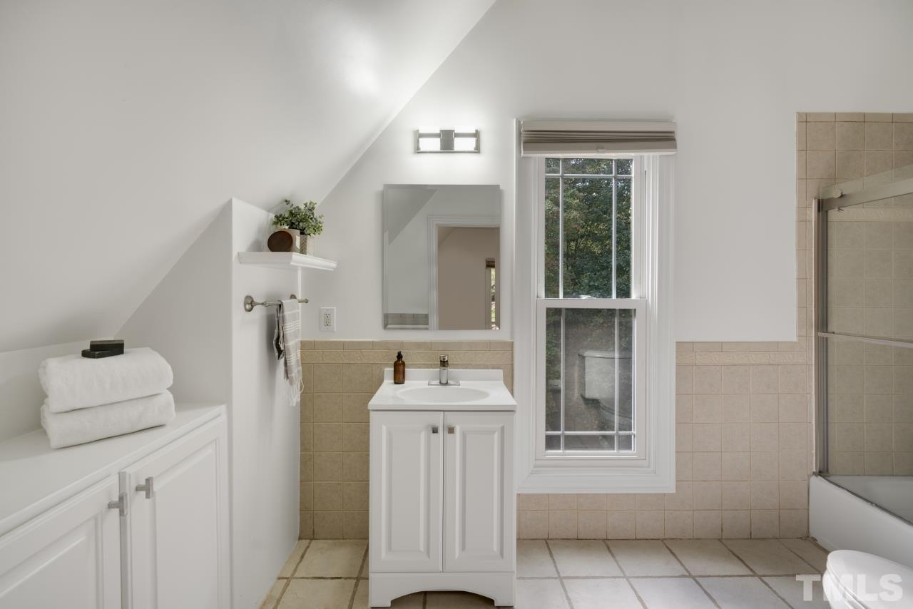 5909 Greenevers Drive Raleigh, NC 27613 - Photo 26 of 30 a bathroom with a sink toilet and mirror