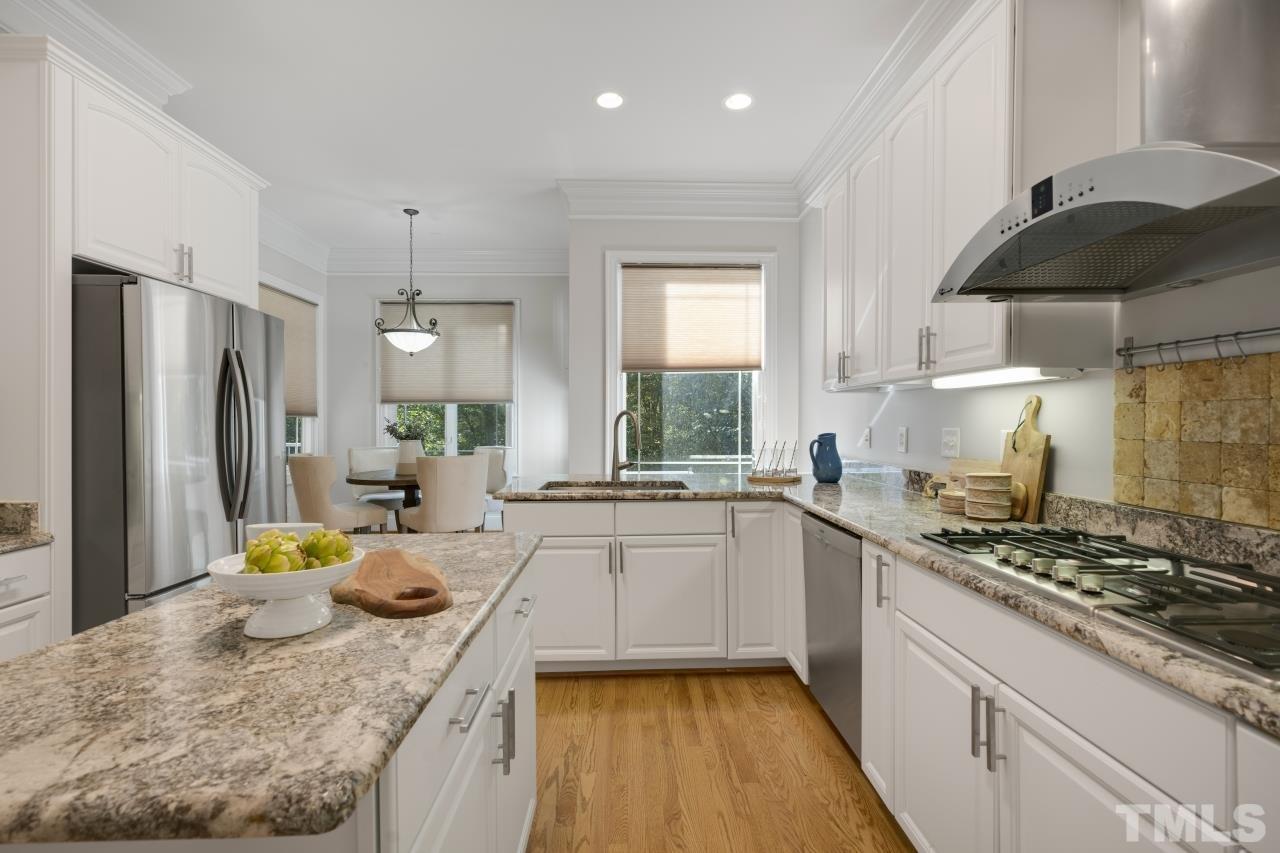 5909 Greenevers Drive Raleigh, NC 27613 - Photo 6 of 30 a kitchen with a sink a stove and refrigerator