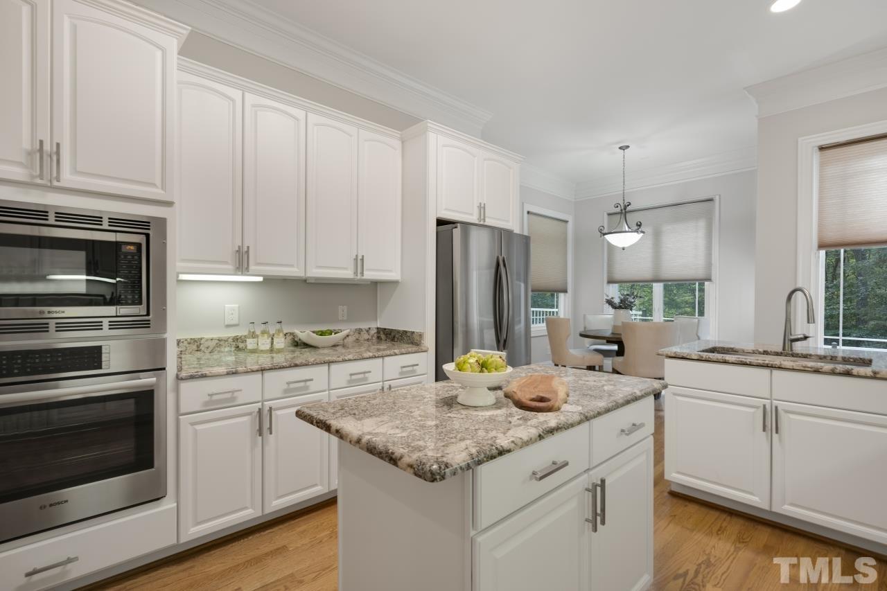 5909 Greenevers Drive Raleigh, NC 27613 - Photo 7 of 30 a kitchen with a sink stove and refrigerator