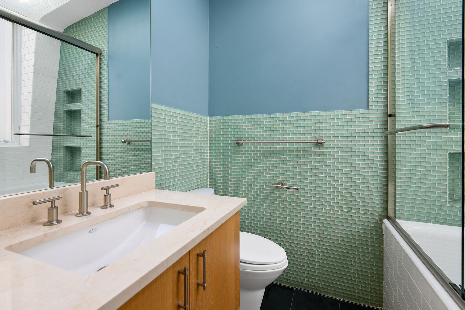 1708 North Mohawk Street Chicago, IL 60614 - Photo 18 of 33 a bathroom with a sink a toilet and mirror