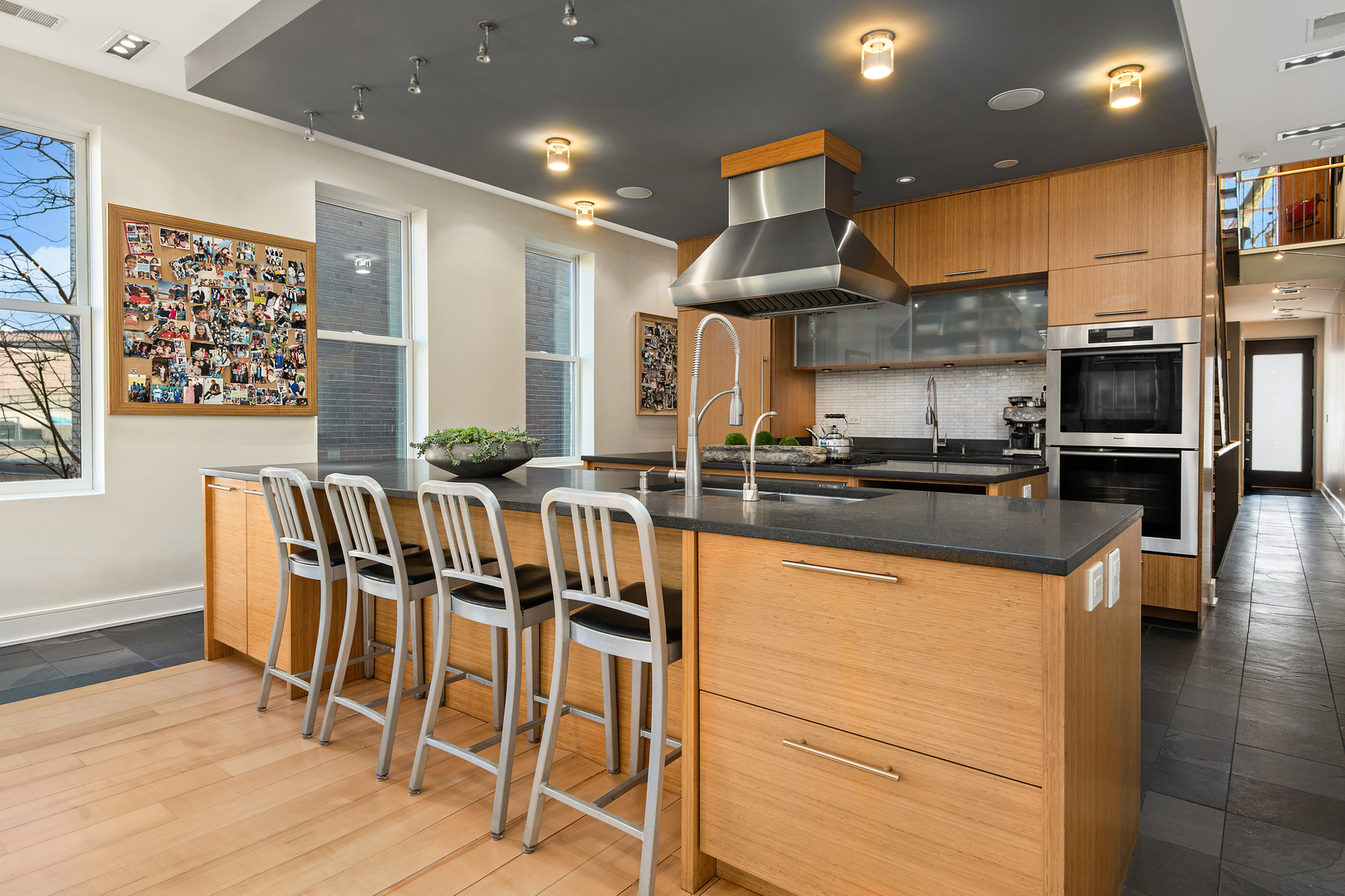 1708 North Mohawk Street Chicago, IL 60614 - Photo 4 of 33 a kitchen with stainless steel appliances kitchen island granite countertop a table chairs sink and cabinets