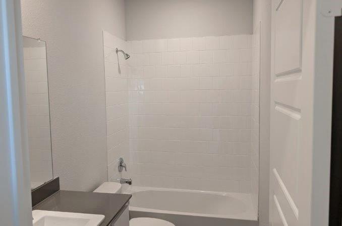 956 Traction Trail Cleburne, TX 76031 - Photo 8 of 15 a bathroom with a shower and a toilet