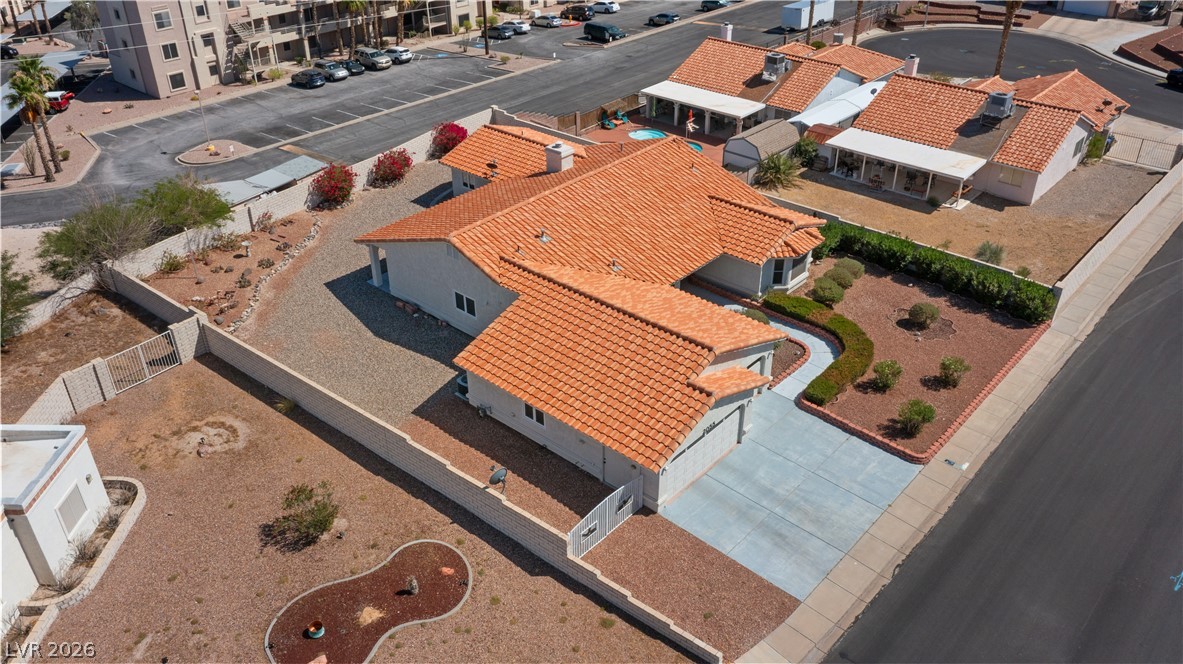 2055 Cholla Way Laughlin, NV 89029 - Photo 84 of 87 An aerial perspective reveals a well-maintained single-family home with a distinctive tile roof and xeriscaped front yard.