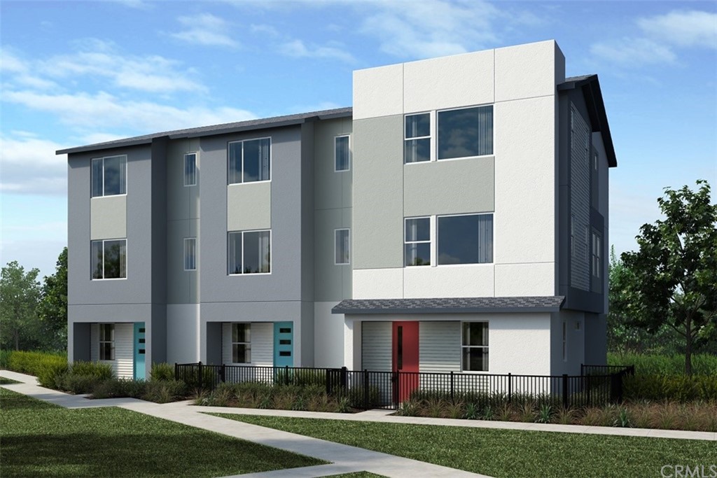 a front view of residential houses with yard and green space