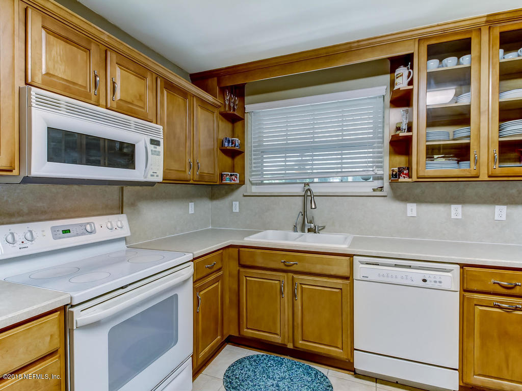 1526 Somerville Road Jacksonville, FL 32207 - Photo 14 of 30 a kitchen with stainless steel appliances granite countertop a sink and cabinets