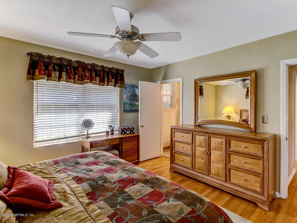1526 Somerville Road Jacksonville, FL 32207 - Photo 22 of 30 a bedroom with a bed a dresser and next to a window