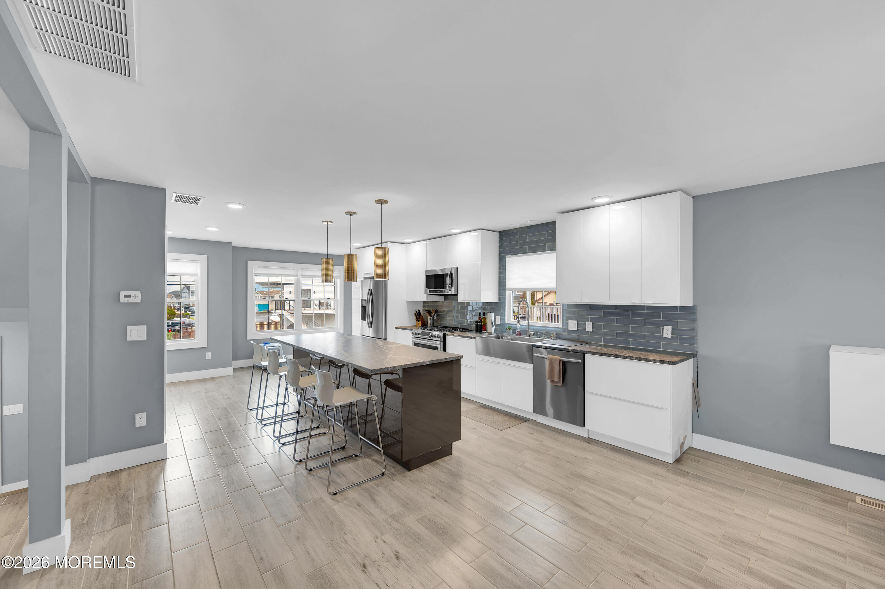 97 Bay View Drive Brick, NJ 08723 - Photo 11 of 65 a kitchen with stainless steel appliances granite countertop a table chairs stove and refrigerator